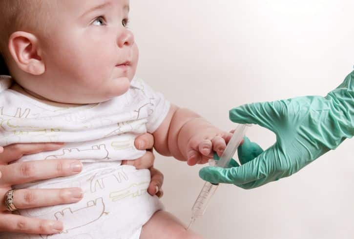 Baby was receiving his scheduled vaccine injection in his right thigh muscle ie intramuscular injection public domain image is in public domain. (https://www.public-domain-image.com/)
